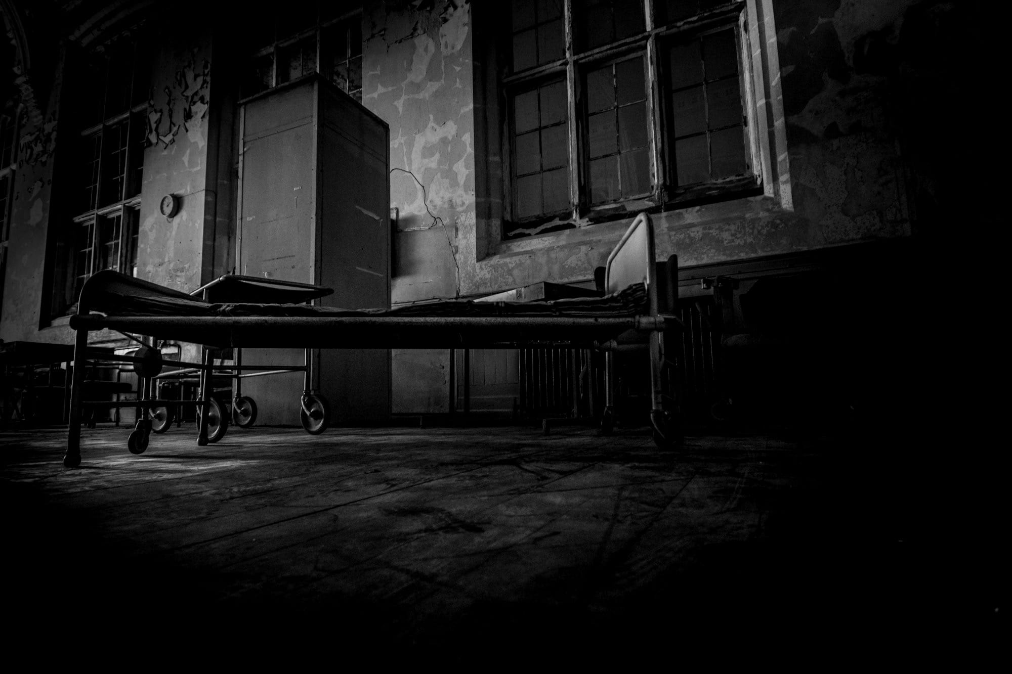 hospital bed on concrete pavement