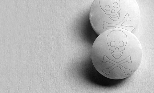 two pills with skull and cross-bones embossed on them