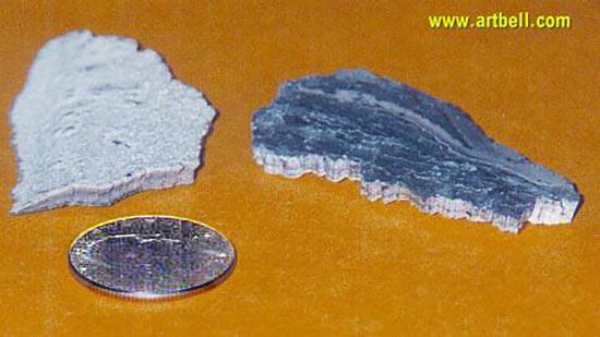 Multilayered chips of metallic material. A quarter provides a scale for these thin.